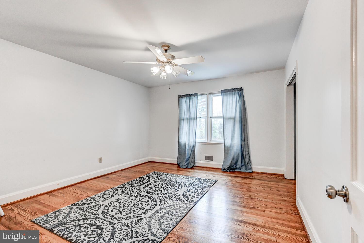 3925 Dance Mill Road Phoenix, MD 21131 - Photo 14 of 26 a view of an empty room with a window and wooden floor