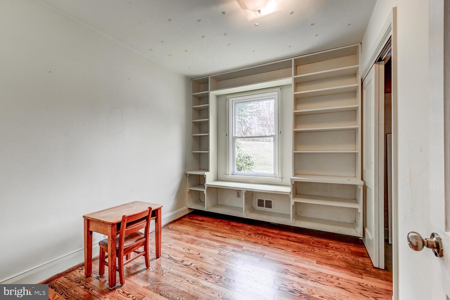 3925 Dance Mill Road Phoenix, MD 21131 - Photo 15 of 26 a view of an empty room with a window and wooden floor