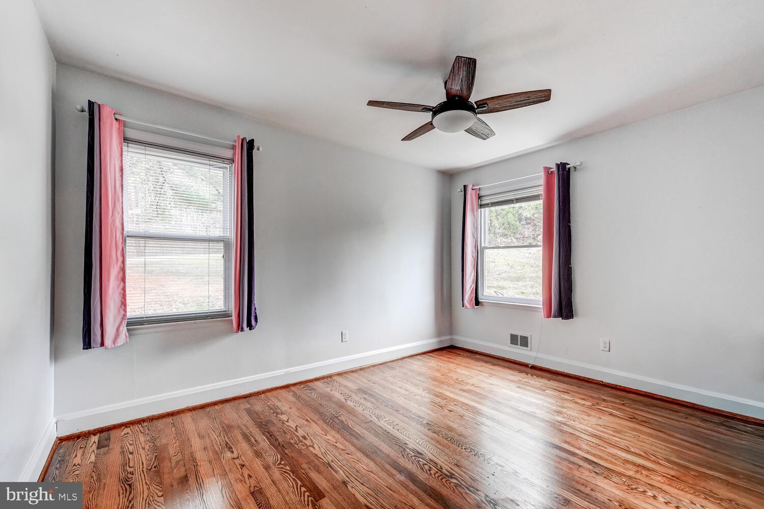 3925 Dance Mill Road Phoenix, MD 21131 - Photo 16 of 26 a view of empty room with wooden floor and fan