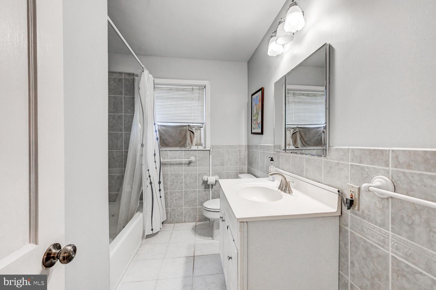 3925 Dance Mill Road Phoenix, MD 21131 - Photo 17 of 26 a bathroom with a sink a toilet and shower