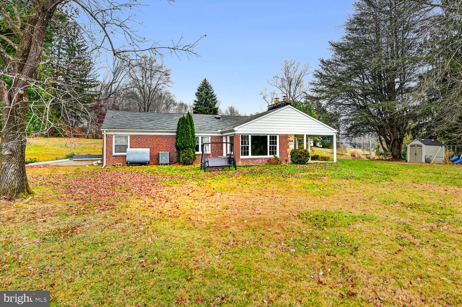 3925 Dance Mill Road Phoenix, MD 21131 - Photo 23 of 26 a front view of a house with swimming pool and large trees