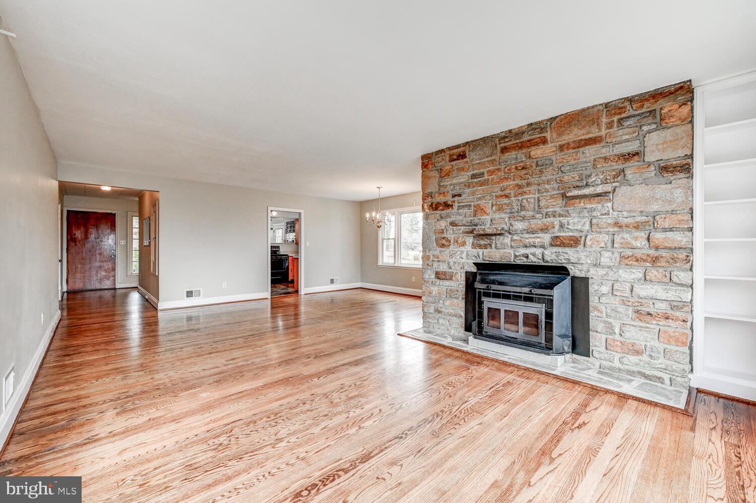 3925 Dance Mill Road Phoenix, MD 21131 - Photo 6 of 26 a living room with wooden floor and a fireplace