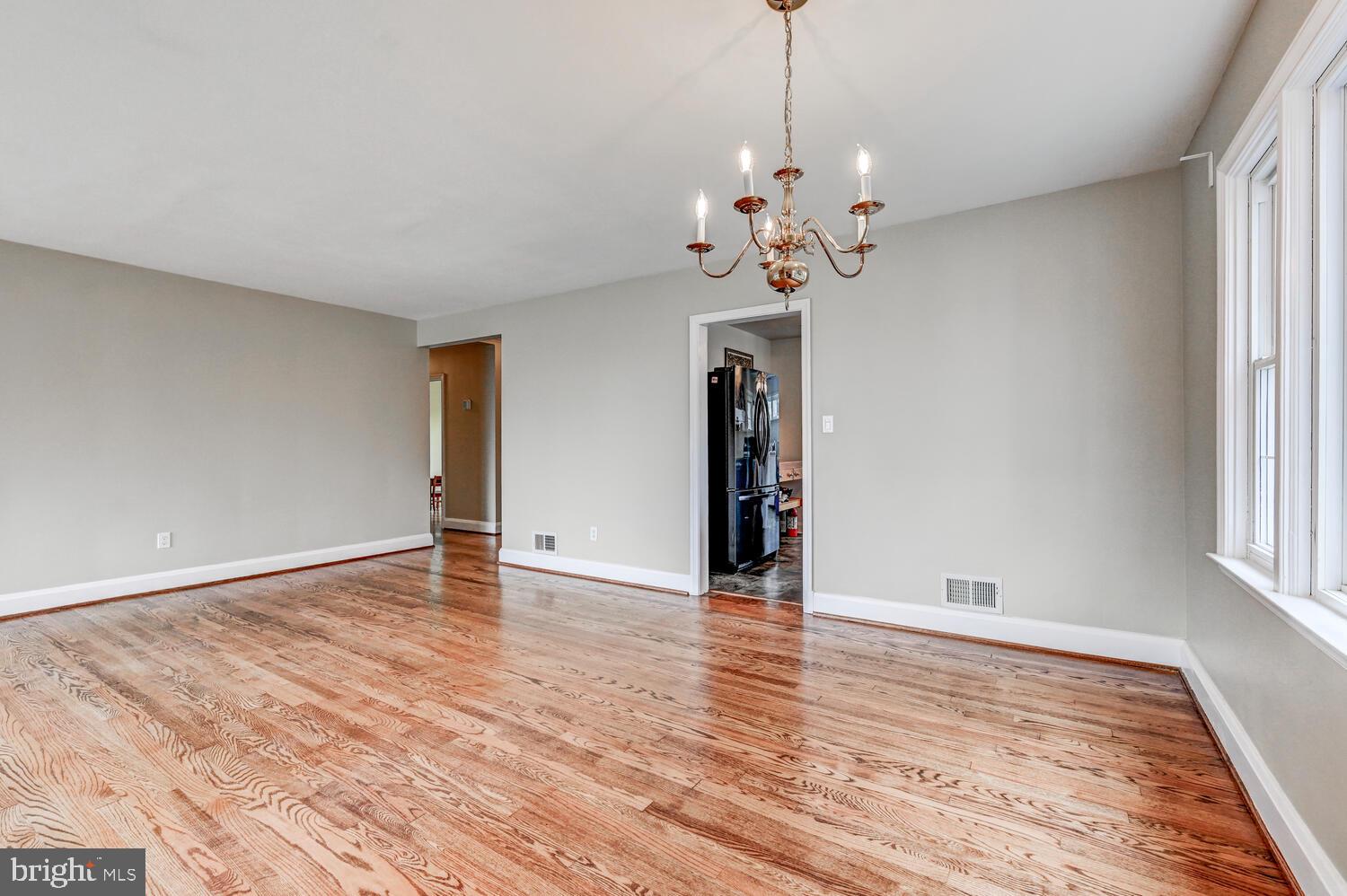 3925 Dance Mill Road Phoenix, MD 21131 - Photo 7 of 26 a view of an empty room with a window and wooden floor