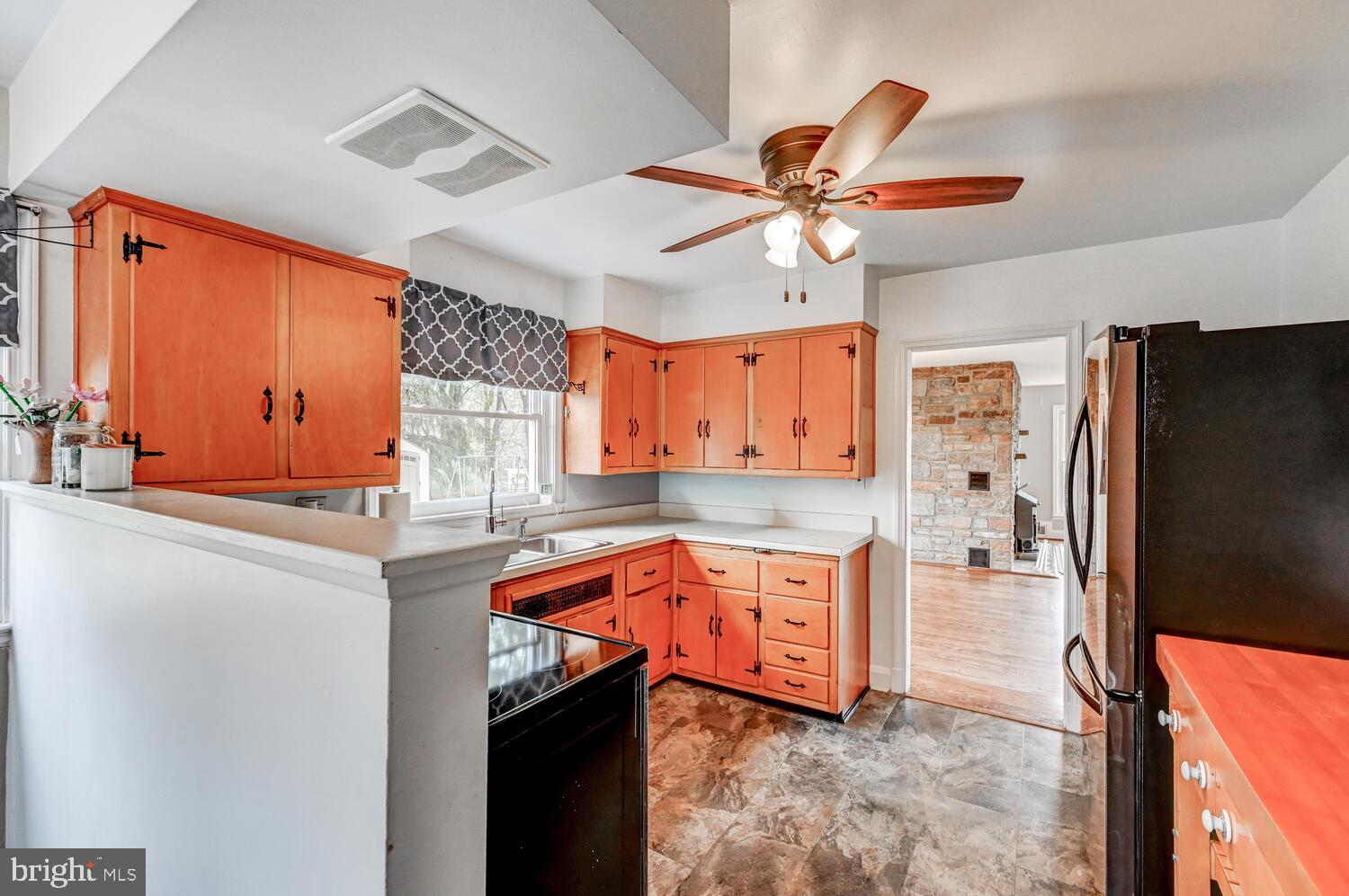 3925 Dance Mill Road Phoenix, MD 21131 - Photo 10 of 26 a kitchen with stainless steel appliances granite countertop a sink a stove and a refrigerator