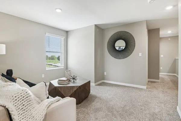 a living room with furniture and a mirror