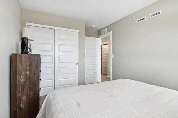a bedroom with a bed and a closet