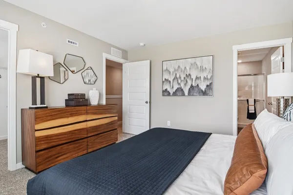 a bedroom with bed and wooden floor