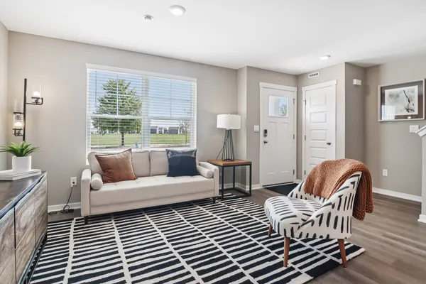 a living room with furniture and wooden floor