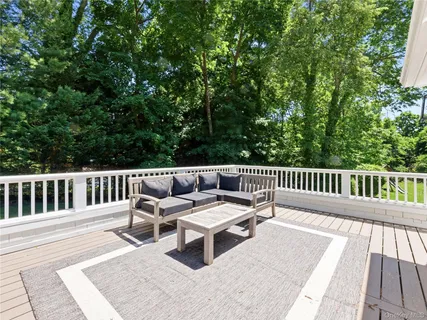 a balcony with wooden floor and fence