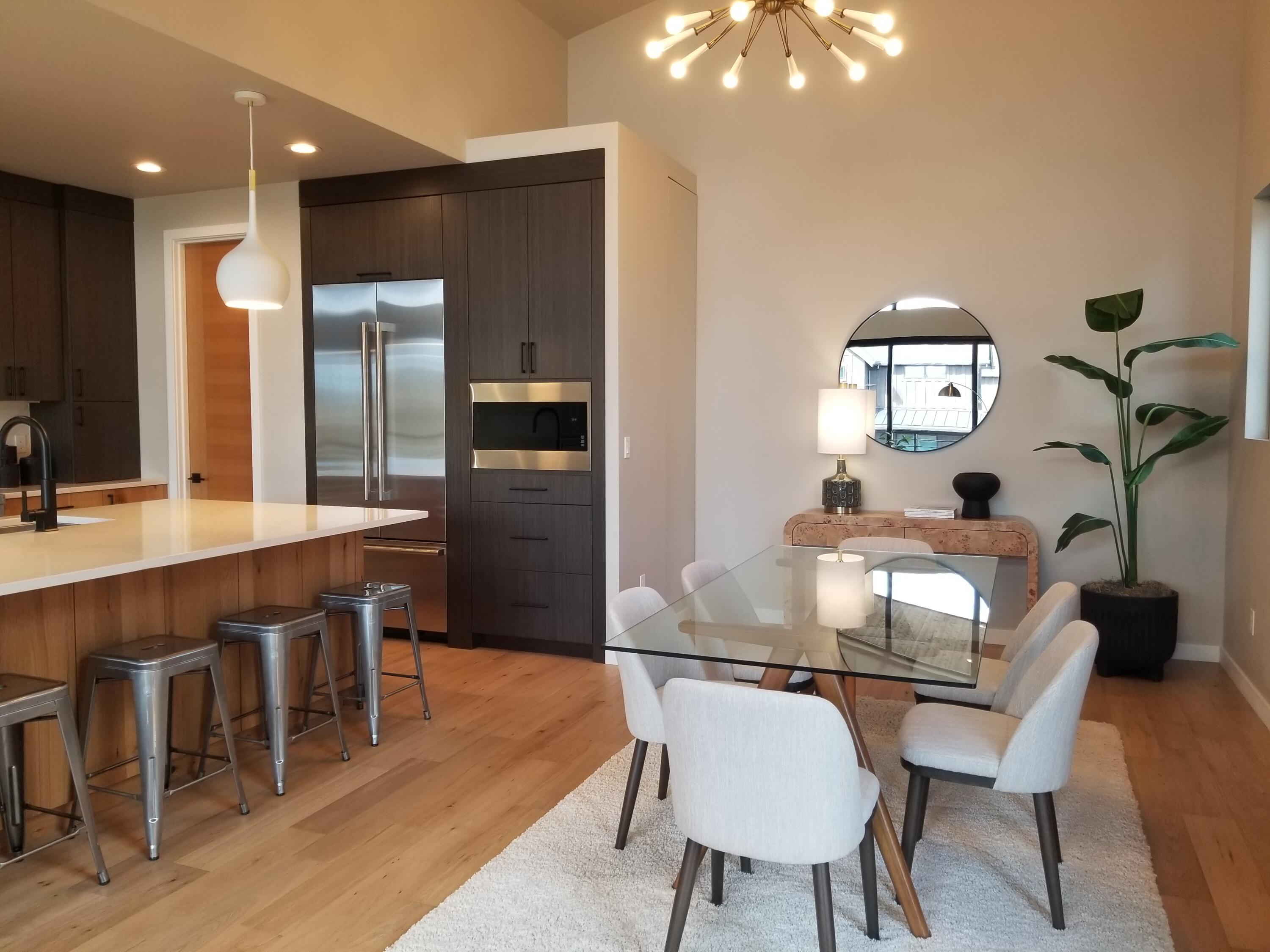 61250 Meeks Trail Bend, OR 97702 - Photo 17 of 43 a kitchen with stainless steel appliances granite countertop a table chairs sink refrigerator and microwave