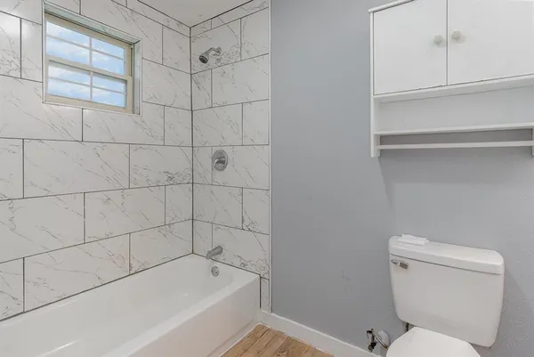 a bathroom with a toilet and bathtub