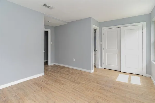 an empty room with wooden floor
