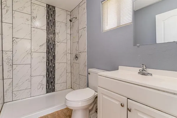 a bathroom with a sink toilet and shower