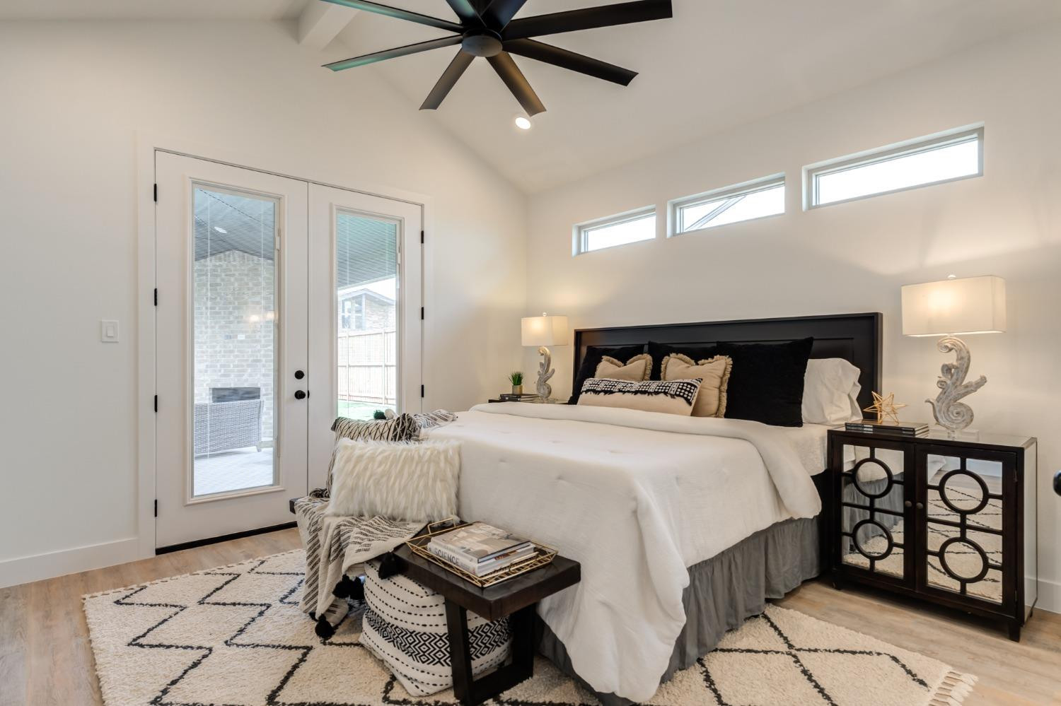 3803 127th Street Lubbock, TX 79423 - Photo 22 of 44 a bedroom with a bed and a chandelier