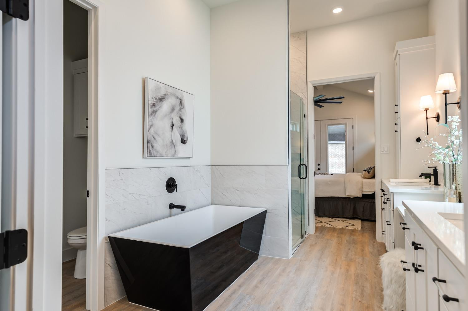 3803 127th Street Lubbock, TX 79423 - Photo 26 of 44 a bathroom with a sink a mirror and a bathtub