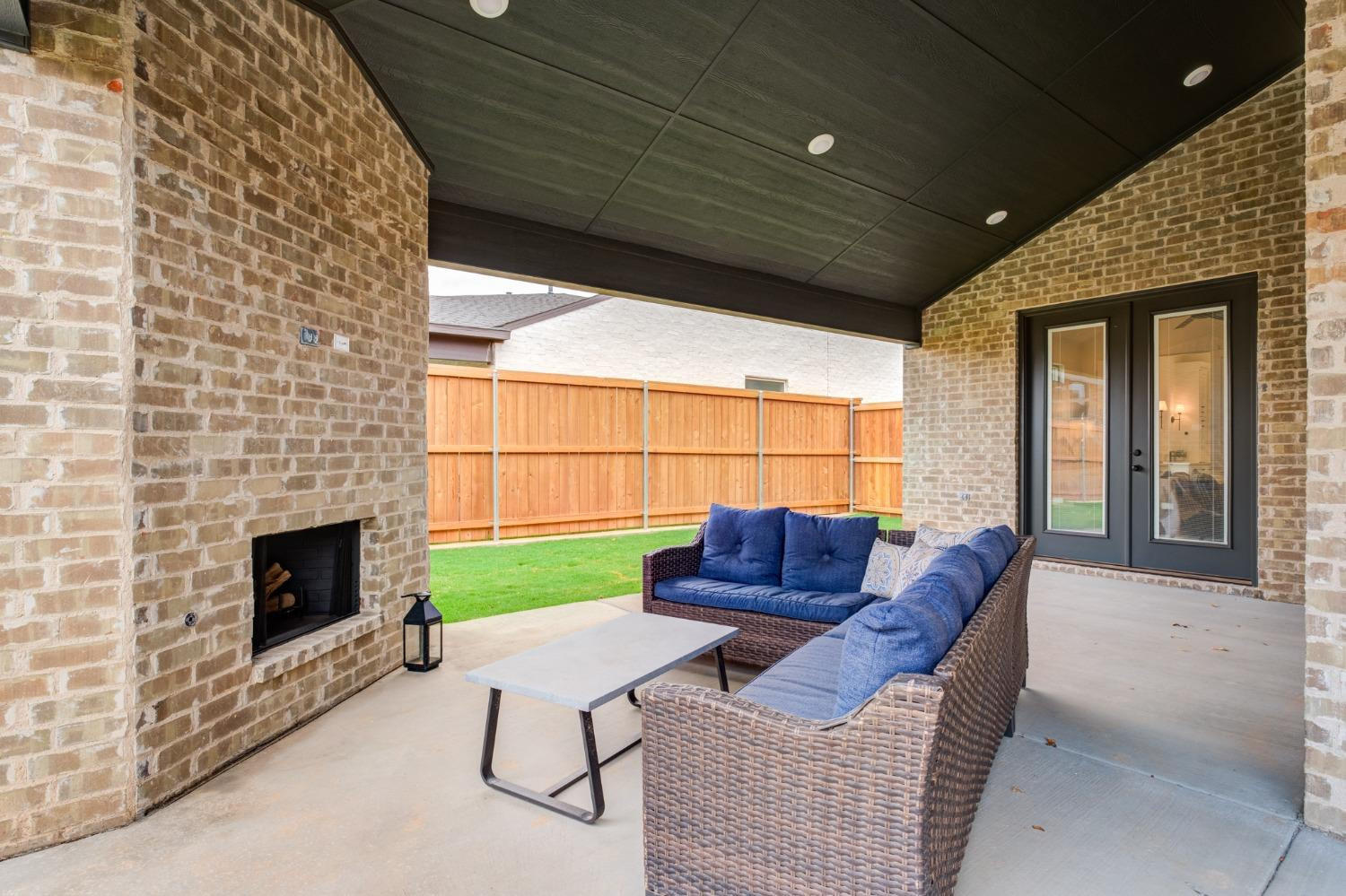 3803 127th Street Lubbock, TX 79423 - Photo 38 of 44 a living room with furniture a fireplace and a flat screen tv