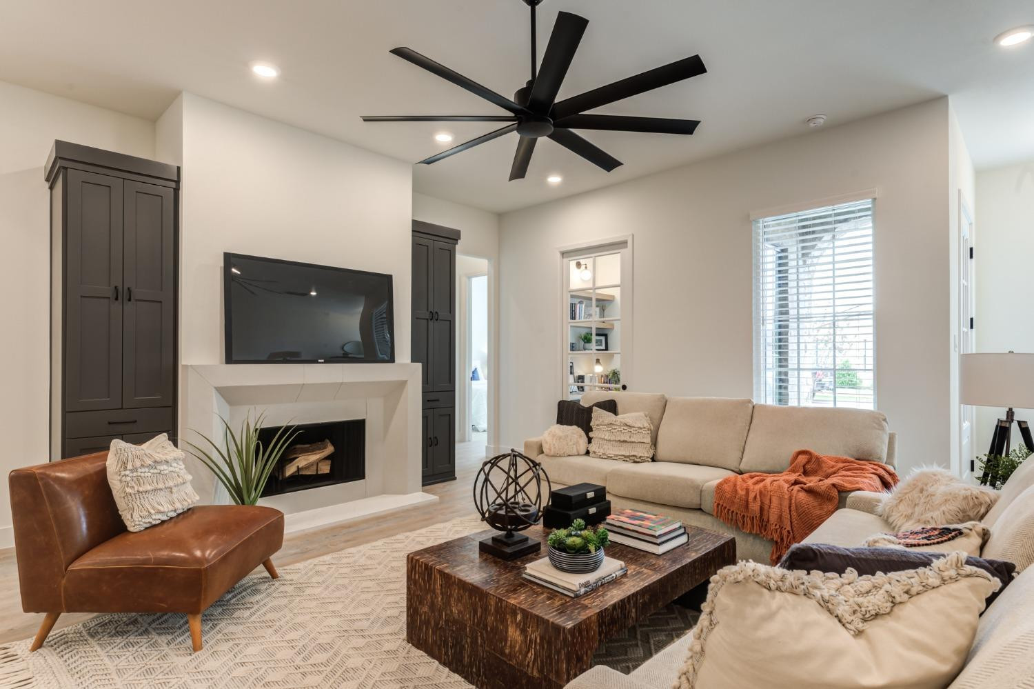 3803 127th Street Lubbock, TX 79423 - Photo 5 of 44 a living room with furniture a fireplace and a flat screen tv