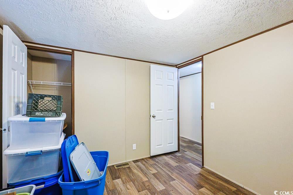 255 Quail Run Road Loris, SC 29569 - Photo 14 of 29 Bedroom with a textured ceiling and wood finished floors
