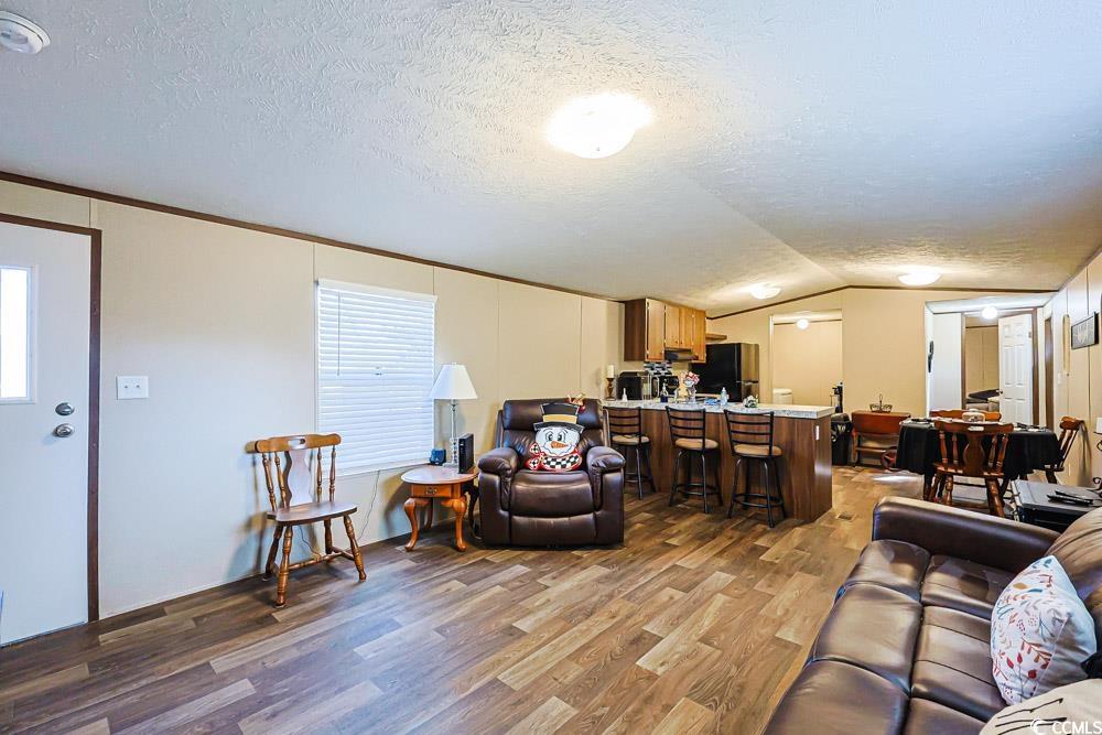 255 Quail Run Road Loris, SC 29569 - Photo 3 of 29 Living area featuring a textured ceiling, lofted ceiling, and wood finished floors