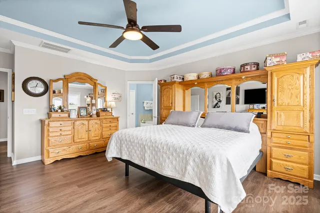 a bedroom with a bed and a view of walk in closet