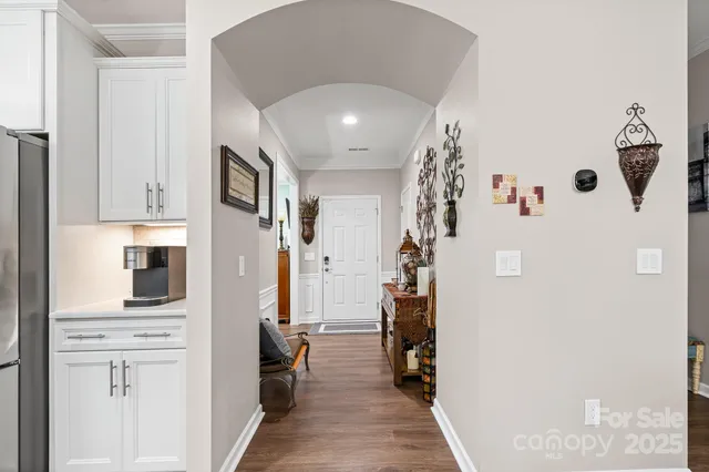 a view of a hallway with entryway and furniture