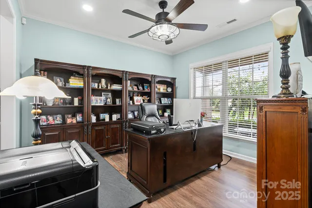 a living room with furniture a window and bookshelf