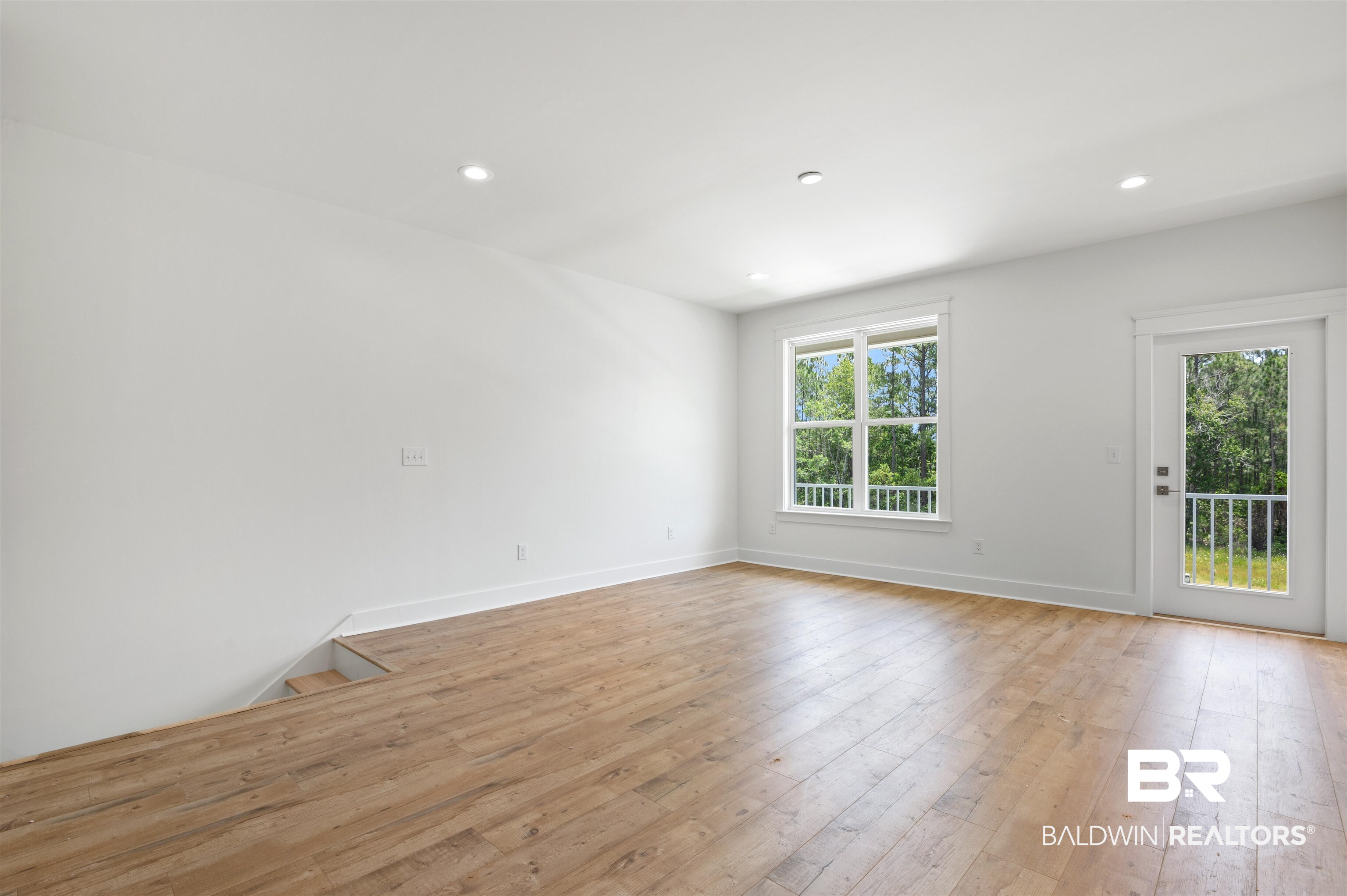 657 Island Way Gulf Shores, AL 36542 - Photo 29 of 59 Empty room featuring healthy amount of natural light, light wood-style floors, baseboards, and recessed lighting