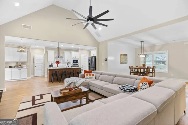 a large kitchen with cabinets table and chairs