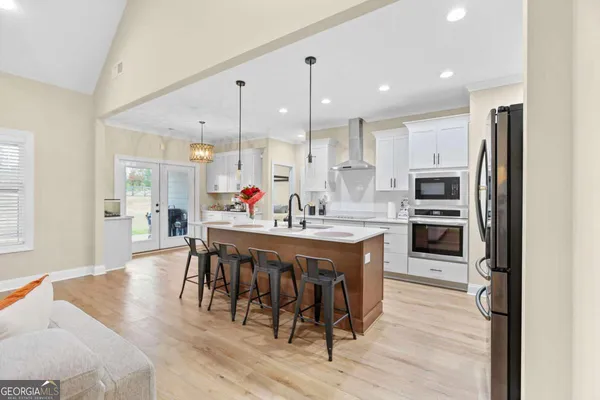 a kitchen with stainless steel appliances granite countertop a sink a stove and a refrigerator
