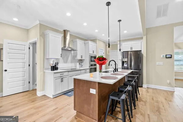 a kitchen with stainless steel appliances granite countertop a sink a stove and a refrigerator