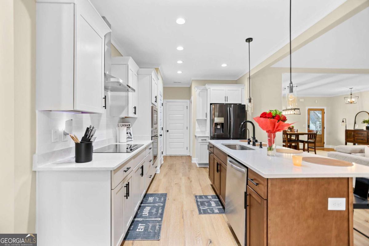 294 Conner Lane Williamson, GA 30292 - Photo 23 of 62 a kitchen with stainless steel appliances a sink stove and refrigerator