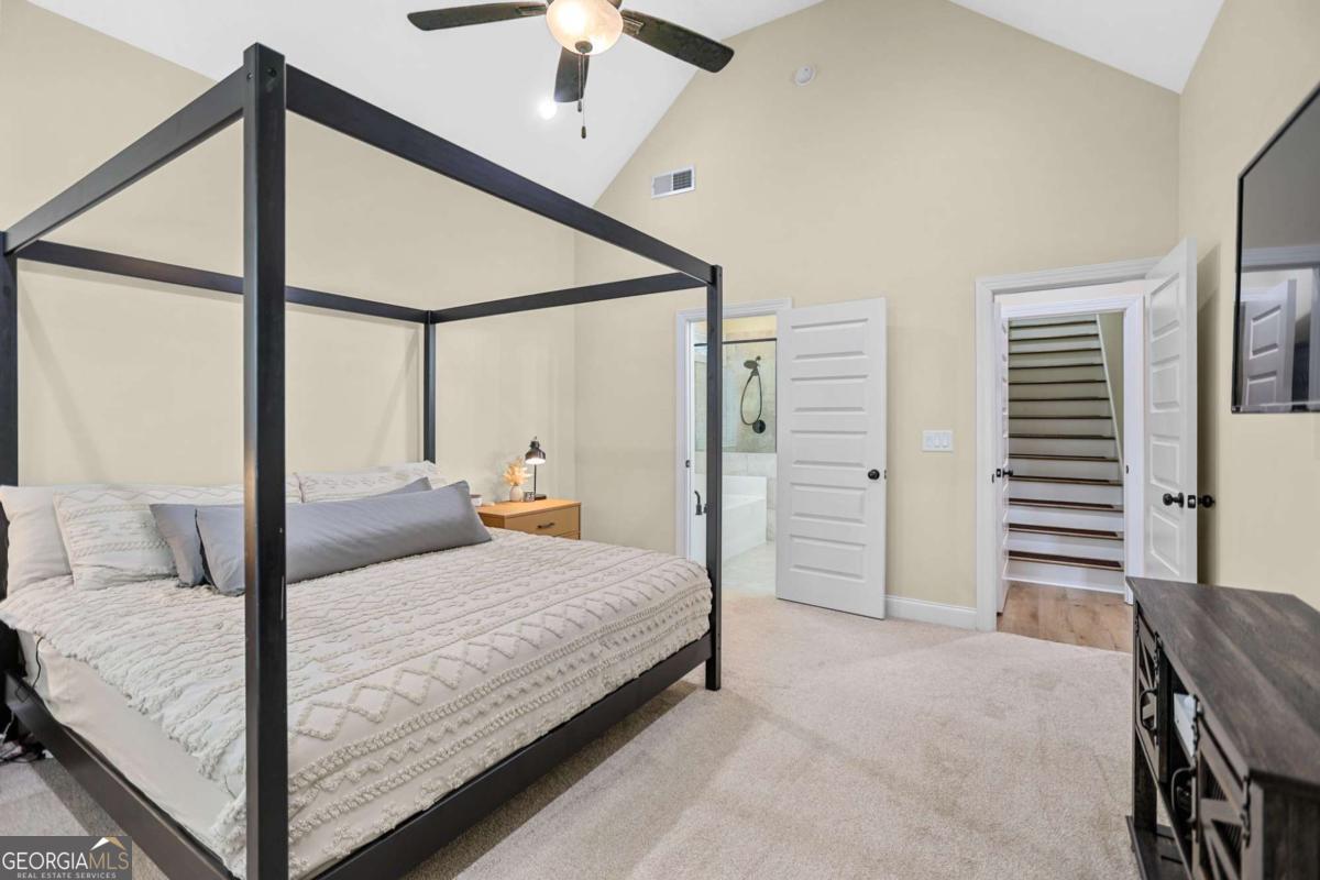 294 Conner Lane Williamson, GA 30292 - Photo 32 of 62 a bedroom with a bed and a chandelier