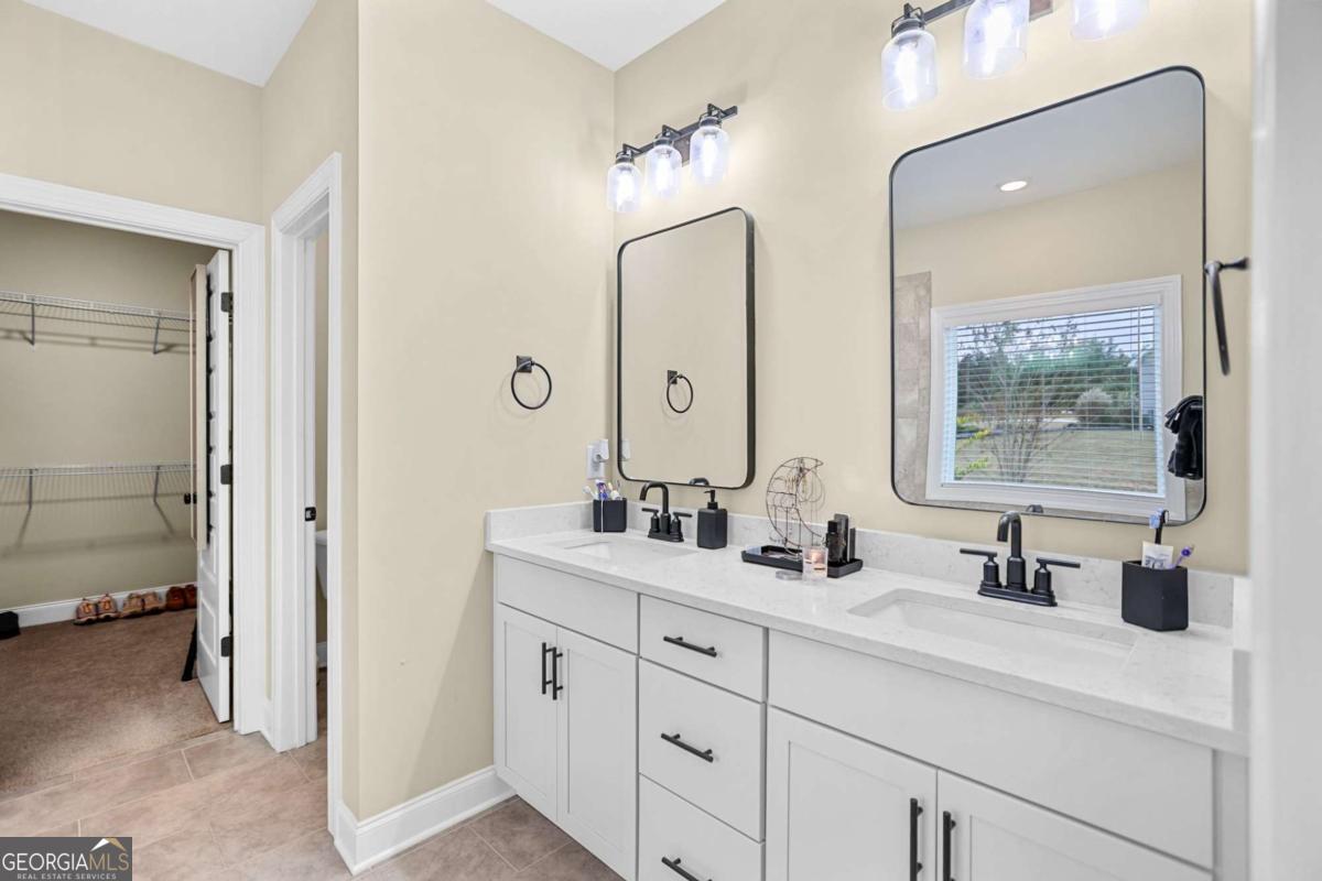 294 Conner Lane Williamson, GA 30292 - Photo 34 of 62 a bathroom with double sink and a mirror