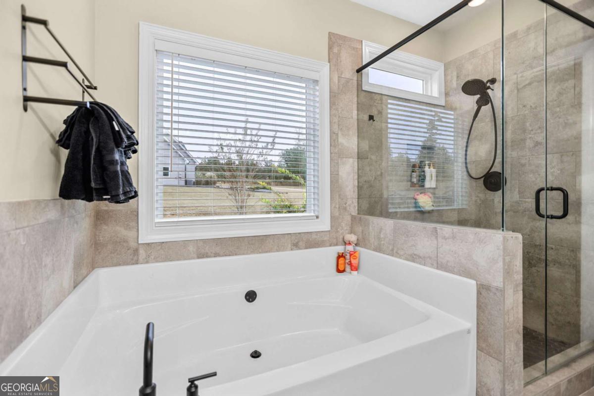 294 Conner Lane Williamson, GA 30292 - Photo 35 of 62 a bathroom with a tub and a shower