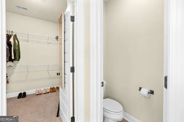 an empty room with a ceiling fan and wooden floor