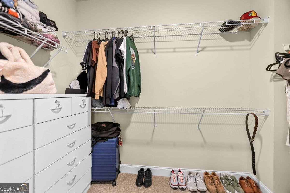294 Conner Lane Williamson, GA 30292 - Photo 38 of 62 a view of walk in closet with clothes and shoes