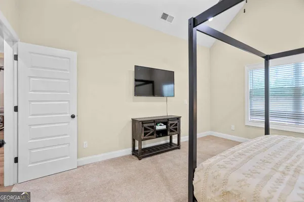 a view of a livingroom with a ceiling fan and a window