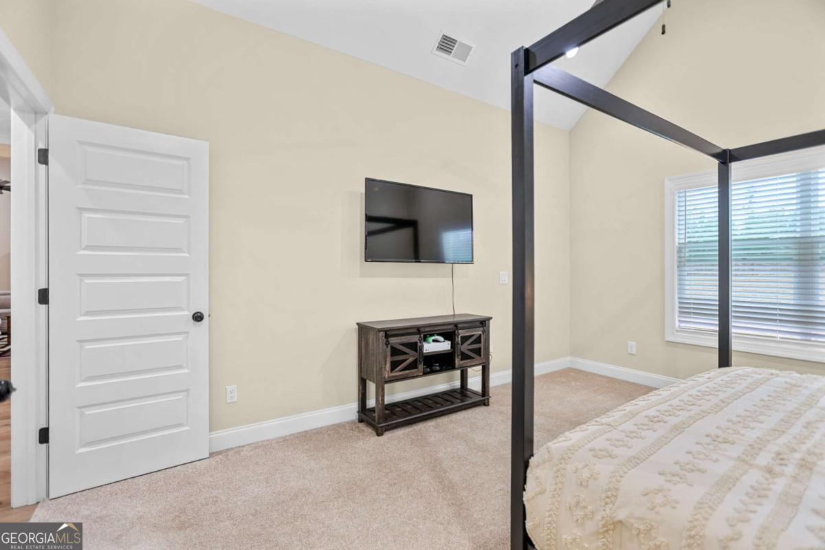 294 Conner Lane Williamson, GA 30292 - Photo 39 of 62 a living room with furniture and a flat screen tv