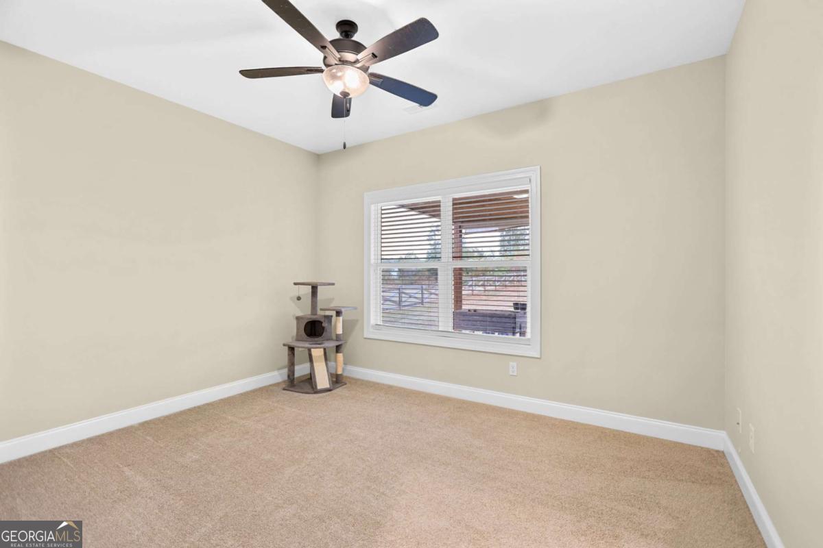 294 Conner Lane Williamson, GA 30292 - Photo 44 of 62 an empty room with a empty space and a ceiling fan