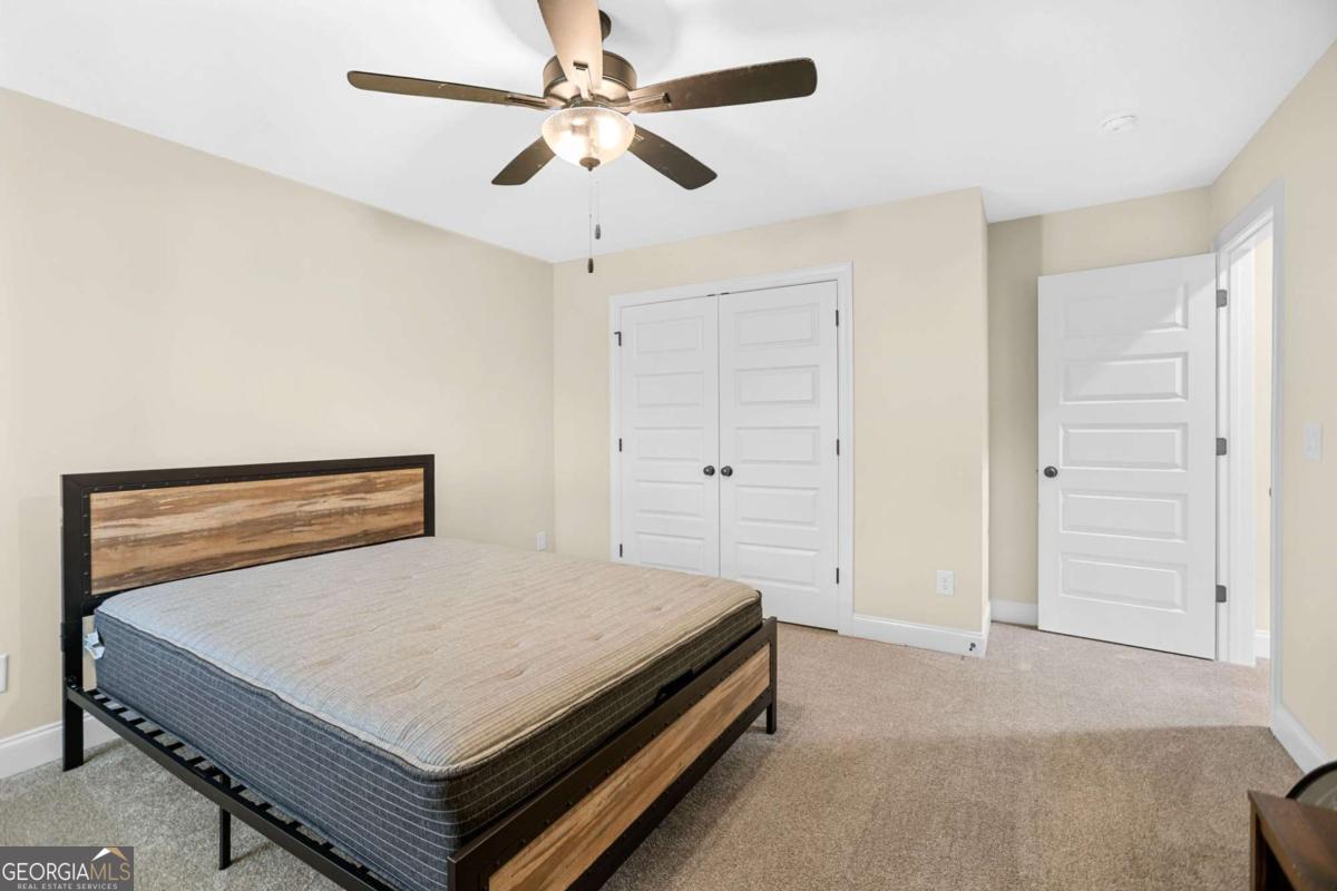 294 Conner Lane Williamson, GA 30292 - Photo 49 of 62 a bedroom with a bed and a ceiling fan