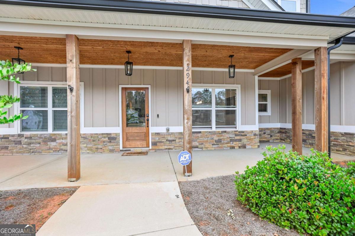 294 Conner Lane Williamson, GA 30292 - Photo 6 of 62 a front view of a house with a yard and glass windows
