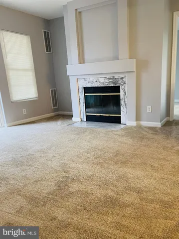 an empty room with a fireplace and a window