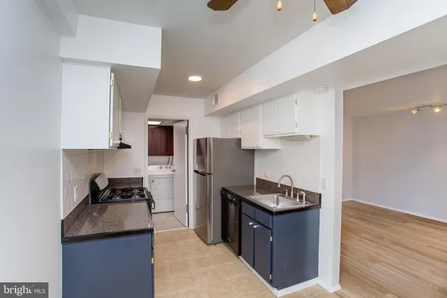 a kitchen with granite countertop stainless steel appliances and wooden cabinets