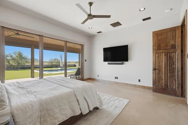 a bedroom with a large bed and a chandelier