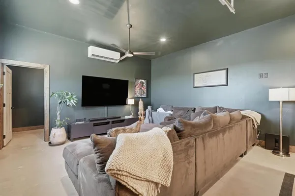 a living room with furniture and a potted plant
