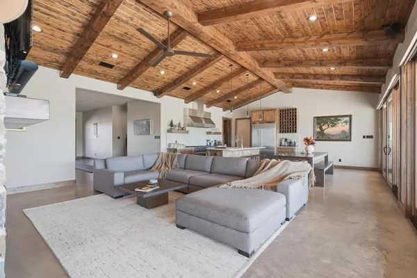 a living room with furniture and a chandelier