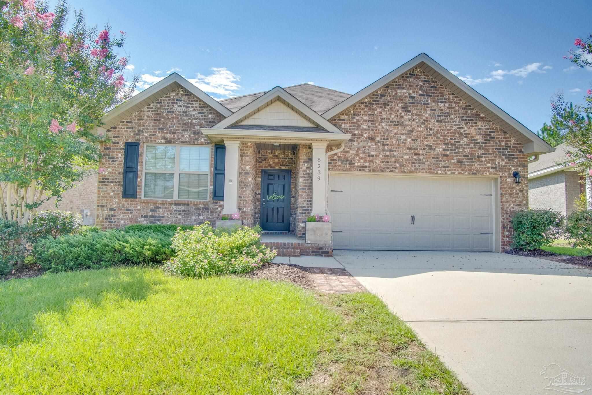 6239 Ladera Trail Pace, FL 32571 - Photo 1 of 27 a front view of a house with garden