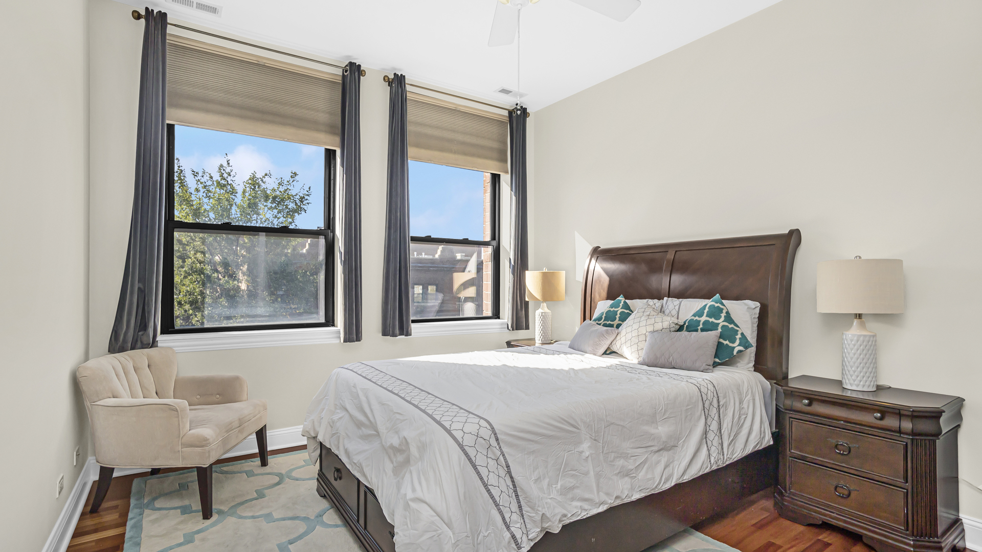 1908 West Irving Park Road, Unit 301 Chicago, IL 60613 - Photo 11 of 24 a bedroom with a bed and a painting on the wall