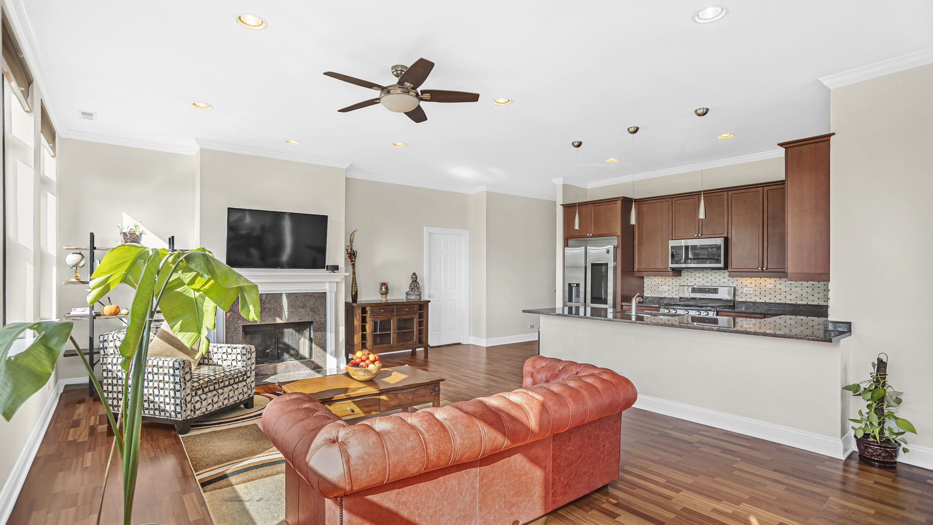 1908 West Irving Park Road, Unit 301 Chicago, IL 60613 - Photo 3 of 24 a living room with furniture and a flat screen tv