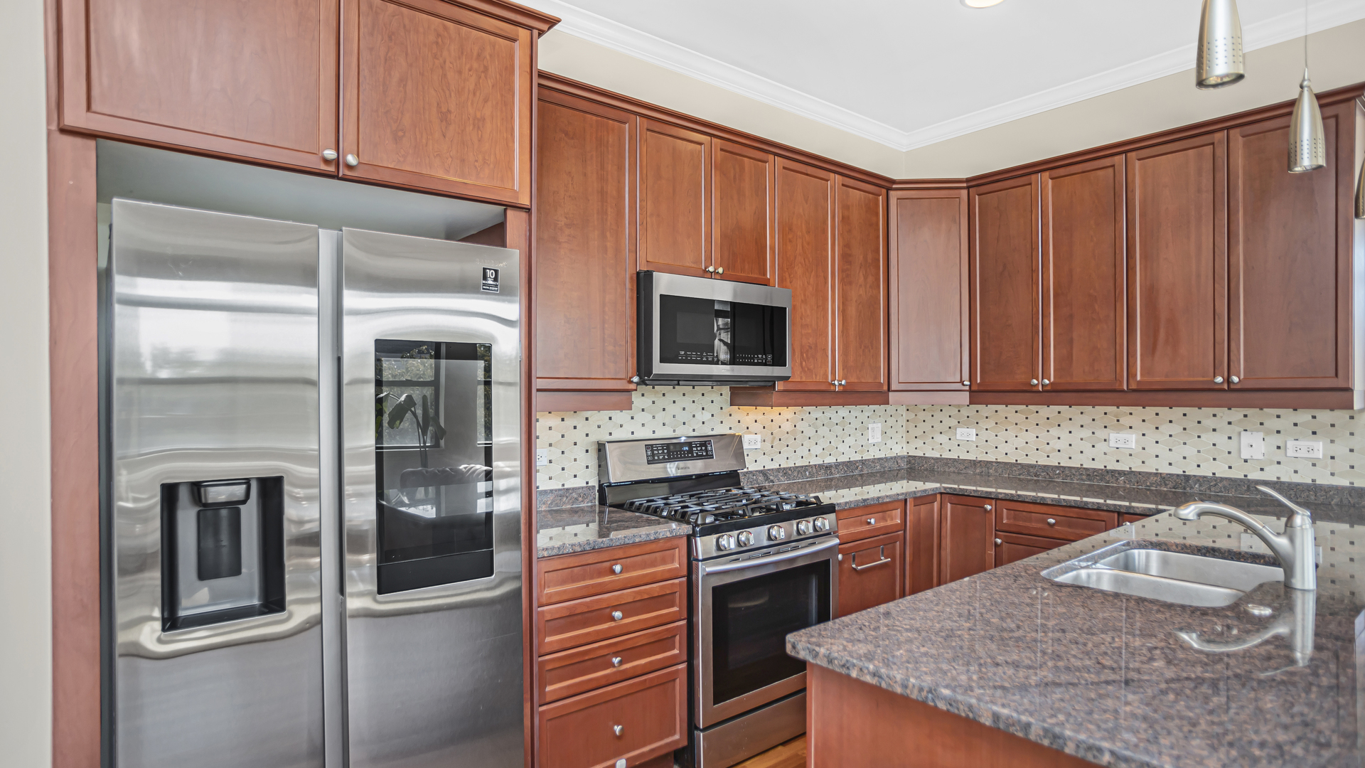 1908 West Irving Park Road, Unit 301 Chicago, IL 60613 - Photo 6 of 24 a kitchen with granite countertop stainless steel appliances and wooden cabinets